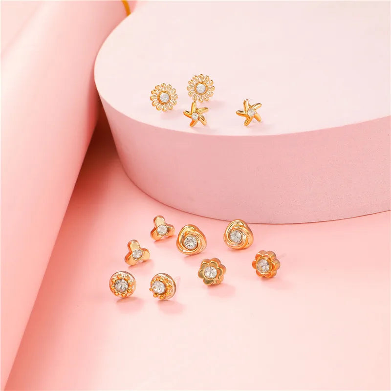 Örhängen 100 par i ask – guldfärgade studs