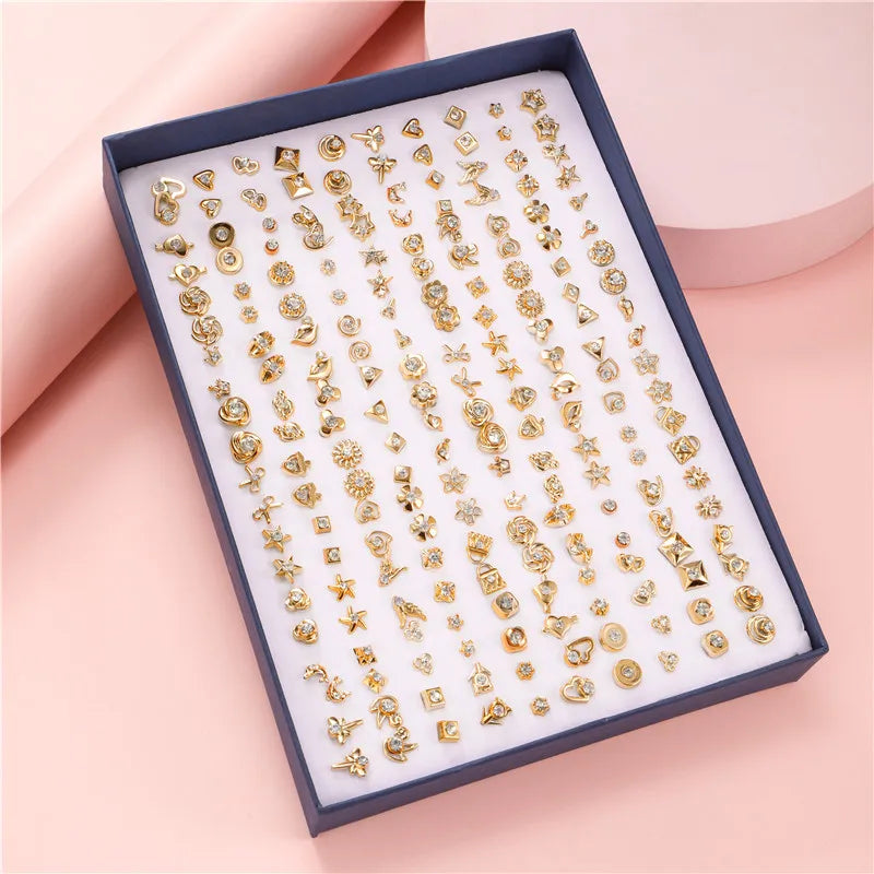 Örhängen 100 par i ask – guldfärgade studs